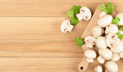 a lot of fresh champignons on a wooden table