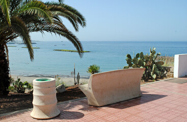 Modern Concrete Bench & Waste Bin on Paved Promenade with Sea View