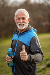 Fototapeta premium Happy senior man is ready for exercising in park.
