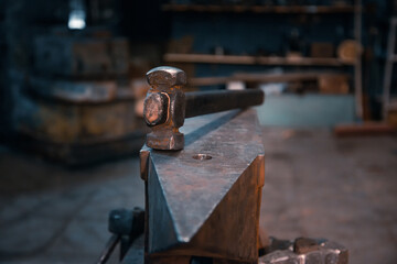 Hammer on an anvil in the forge, without people.