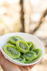 Closeup shot of sliced kiwi on a white pot