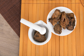 Chinese herbal medicine rhubarb and medicine mortar on bamboo slips