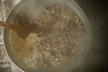 Boil the meat soup in a large pot.