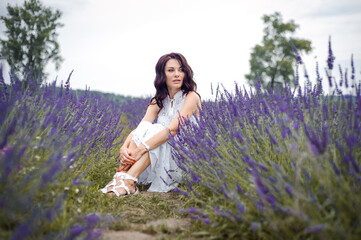 Beautiful woman sitting on lavender