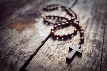 Rosary beads and religious crucifix cross background
