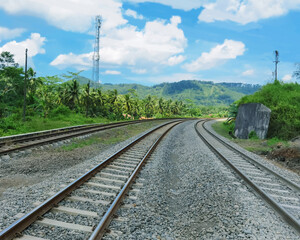 Fototapeta na wymiar railroad tracks with sunny natural scenery