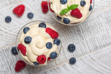 Top view of mascarpone whipped cream with berries - Italian dessert.  Horizontal image.