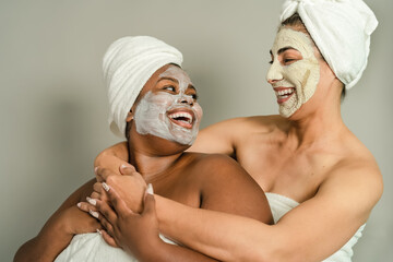 Happy multiracial women having skin care spa day - People wellness lifestyle concept