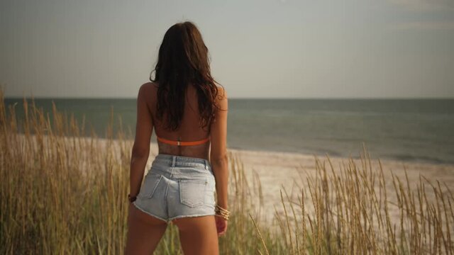 Boho Woman on the Beach Near the Sea