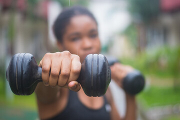 Young lady using a dumbbell