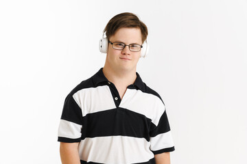 Young man with down syndrome using headphones while listening music