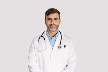 Male doctor standing on white background