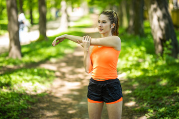 Fitness woman doing stretch exercise stretching her arms - tricep and shoulders stretch wearing a smartwatch activity tracker. Women stretching for warming up before running or working out.