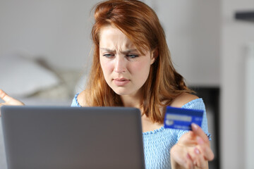Confused woman buying online with credit card