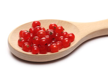 Fresh currant pile in wooden spoon isolated on white background