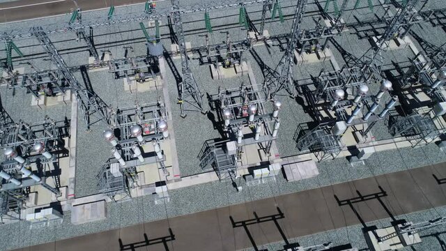 New equipment installed at electricity distribution substation with large switchyard on sunny summer day bird eye view