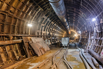 Abandoned subway tunnel construction. Deep metro line construction. Old mine for the construction of the subway - obrazy, fototapety, plakaty