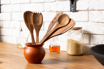 Set of wooden kitchen equipment on brick background