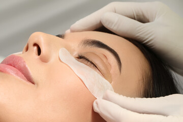 Obraz na płótnie Canvas Young woman undergoing eyelash lamination, closeup. Professional service