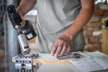 A carpenter works with professional woodworking tools.