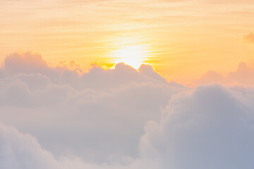 beautiful yellow sunlight of sun while sunrise or sunset with soft white cloud on sky for wallpaper or background