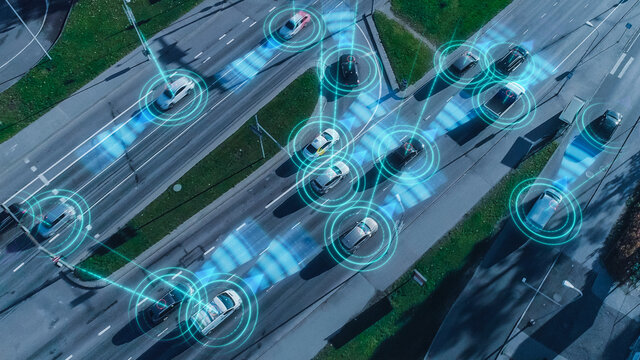 Top Down Aerial Drone: Autonomous Self Driving Cars Moving Through City. Concept: Artificial Intelligence Scans Surrounding Environment, Detecting Cars, Avoids Traffic Jams And Drives Safely.