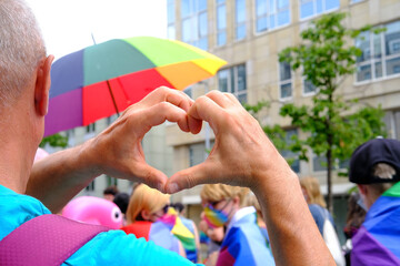 members of LGBTq movement, Gay pride parade in city with rainbow flags, demonstration of people,...