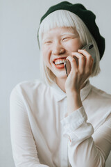 Cool and stylish albino girl talking on her phone - obrazy, fototapety, plakaty