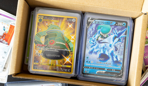 Hamburg, Germany - 07192021: top view photo of japanese TCG pokemon cards in top loader from the series silver lance in collecting paper box.