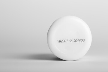 Lot number and manufacturing date on the bottom of the product with isolated white background.