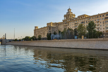 Fototapeta premium Moskva River and urban architecture of the capital downtown on a summer day. Moscow, Russia
