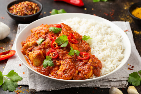 Spicy Chicken Pathia curry with basmati rice in a white plate. healthy food.