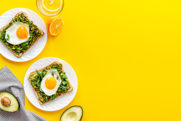 Open sandwich with avocado spinach cream and eggs. Top view