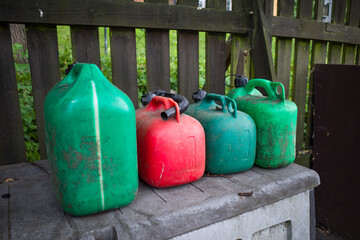 Stockholm, Sweden Red and green gasoline gerry cans sitting on a dock.