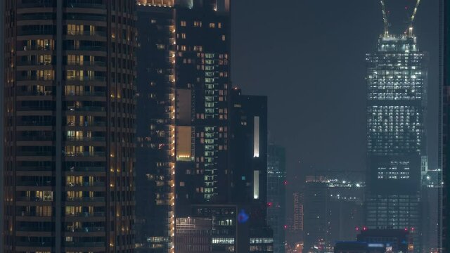 Cranes working on modern constraction site works of new skyscraper timelapse