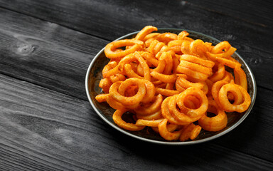 Golden Spicy Seasoned Curly Fries on rustic plate. ready to eat