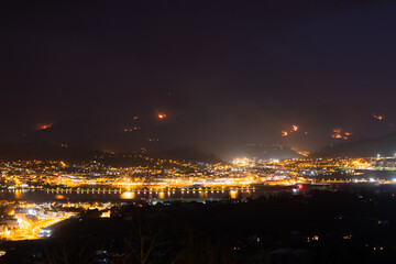 Fototapeta na wymiar Night at Irun while a wild fire destroys the near mountains.