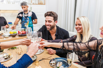 Group of friends making a toast dinner at home