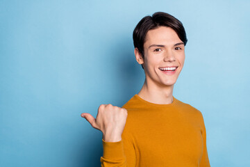 Profile side photo of young guy happy positive smile indicate thumb empty space ad advise decision...