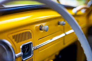 Restored yellow classic car interior. Photo taken in natural light.