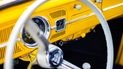 Restored yellow classic car interior. Photo taken in natural light.
