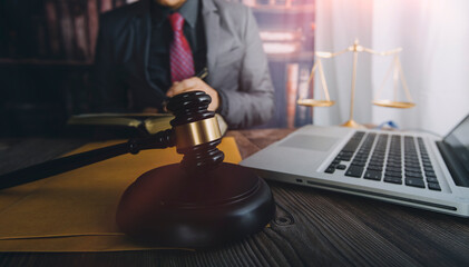 Business and lawyers discussing contract papers with brass scale on desk in office. Law, legal services, advice, justice and law concept picture with film grain effect