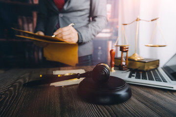 Business and lawyers discussing contract papers with brass scale on desk in office. Law, legal services, advice, justice and law concept