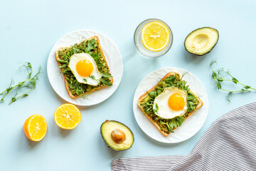 Open sandwich with avocado spinach cream and eggs. Top view