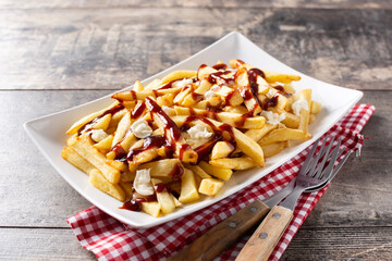 Obraz premium Traditional Canadian Poutine on wooden table. Top view. 
