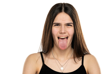 portrait of a beautiful teenage girl crawling her tongue