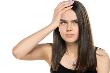 portrait of a beautiful teenage girl looking up and holding her head