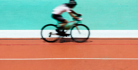 Cyclist biking at a stadium - obrazy, fototapety, plakaty
