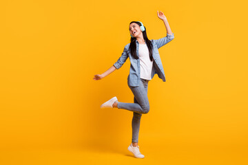 Fototapeta na wymiar Full length of charming positive person look empty space dancing toothy smile isolated on yellow color background