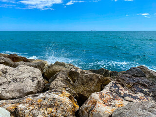 Fototapeta na wymiar View of the sea reaching the cliffs in Malaga Mediterranean Sea in the summer